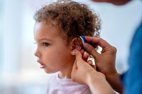 A child with a hearing aid