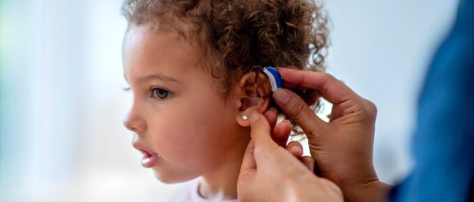 A child with a hearing aid