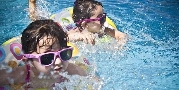 a couple of children in a pool