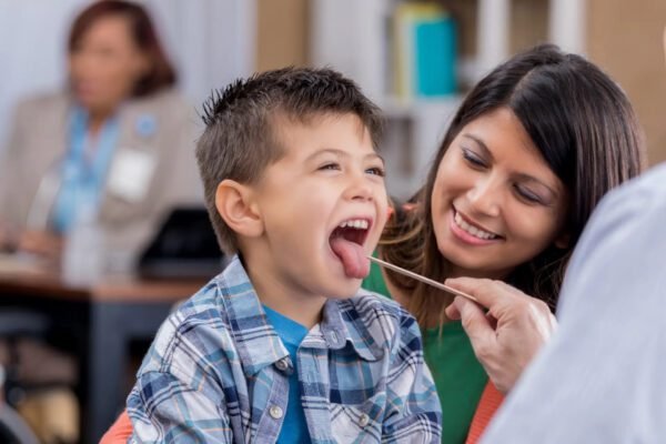 a doctor examining a child's throat