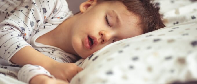 a child sleeping in bed