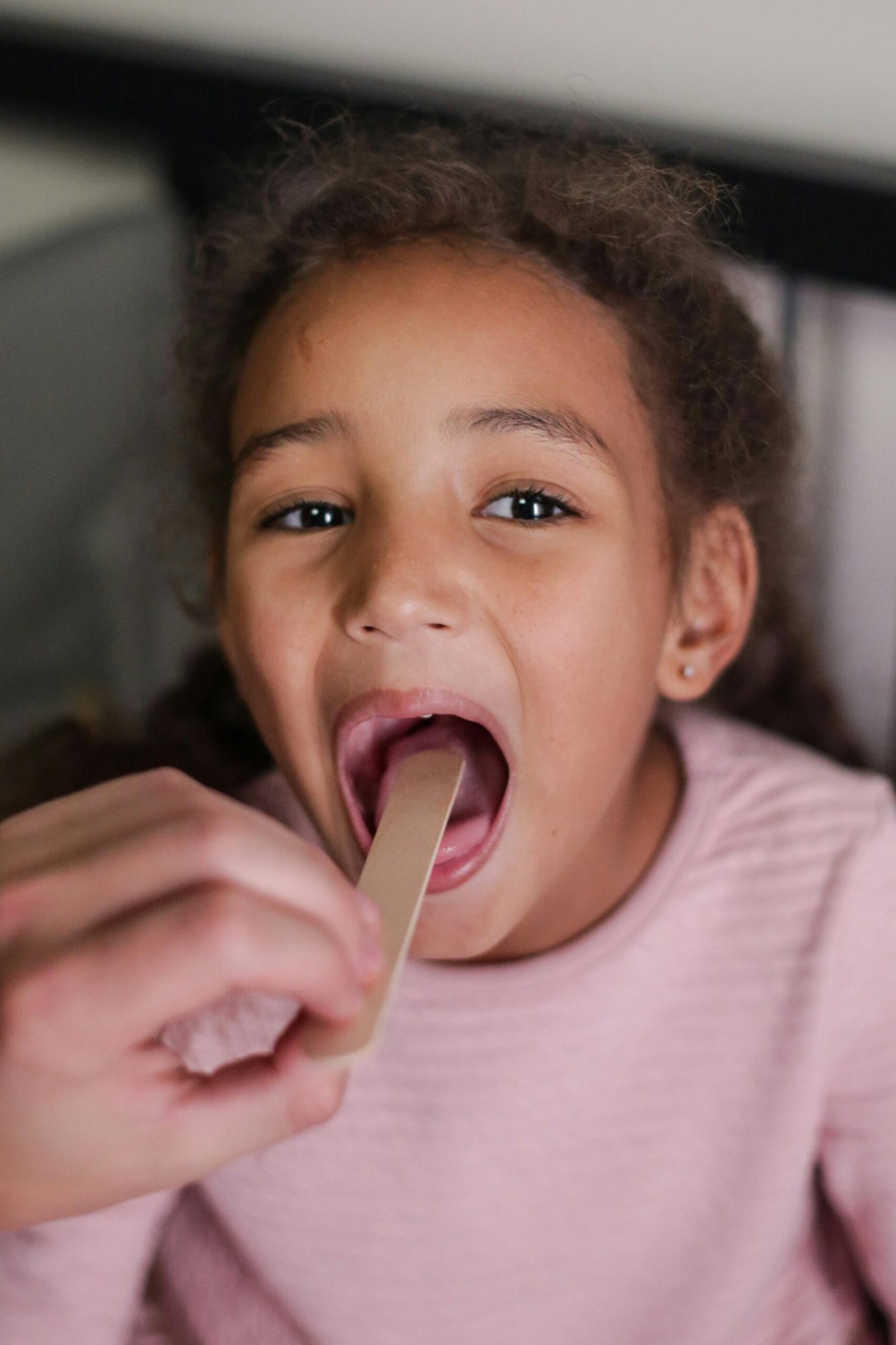 Child undergoing tonsil exam
